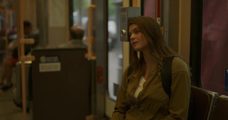 A woman is riding the bus