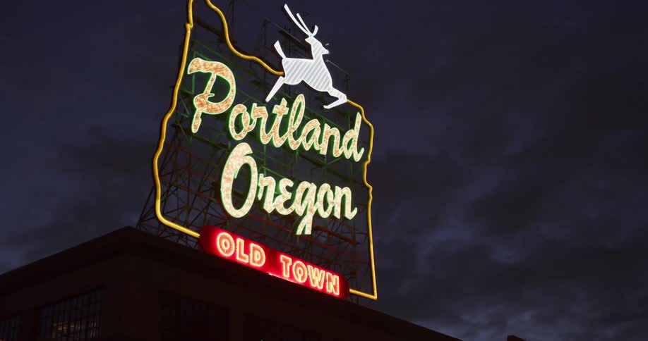 Sign with a deer on it introducing the city