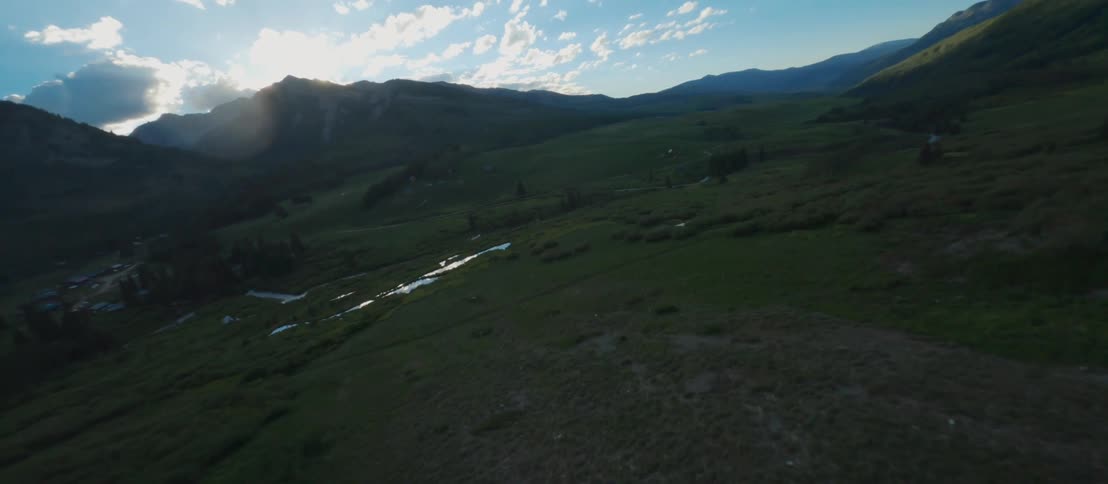 A mountain valley covered in vegetation on a sunny day