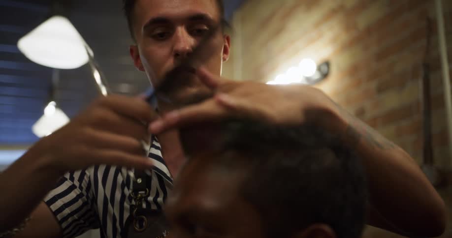 Barber cutting customers hair at a barber shop