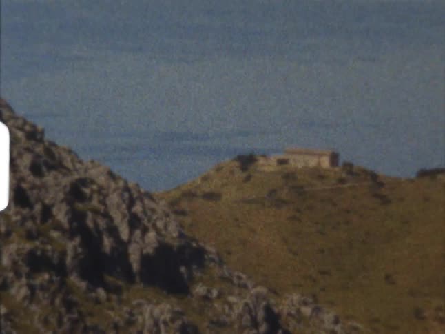 A building perched on a mountain peak on 8mm