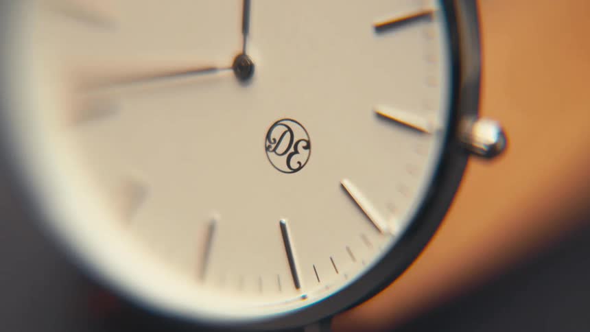 Out of focus close up of a analog clock wristwatch dial