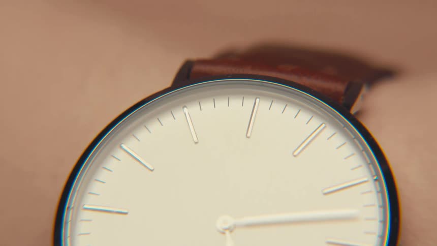 A white wristwatch with a leather strap