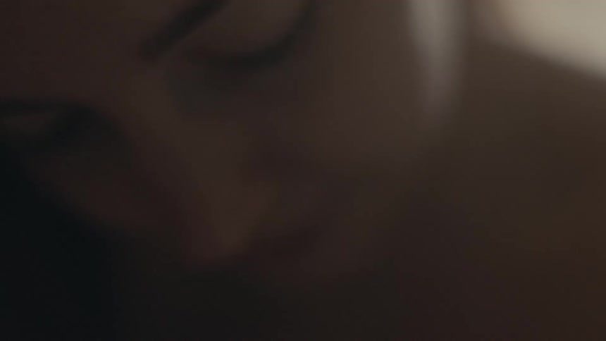 Close up of the face of a freckled young woman
