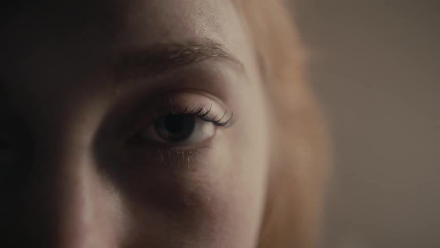 A close up view of a womans face is displayed