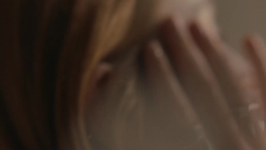 A woman running her hands through her hair