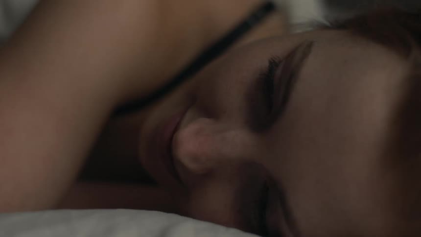 A white woman lying in bed