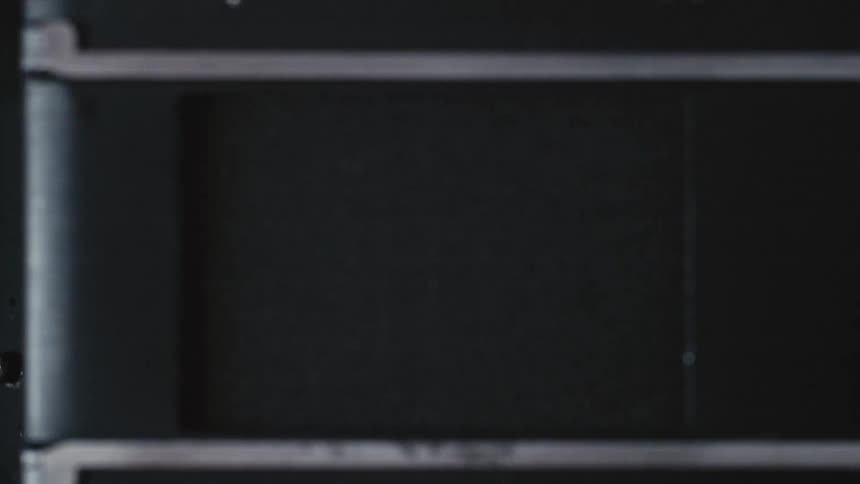 A shutter opens on a camera and reveals the lens