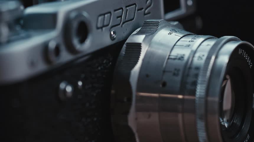 A silver lens is attached to a black and silver camera
