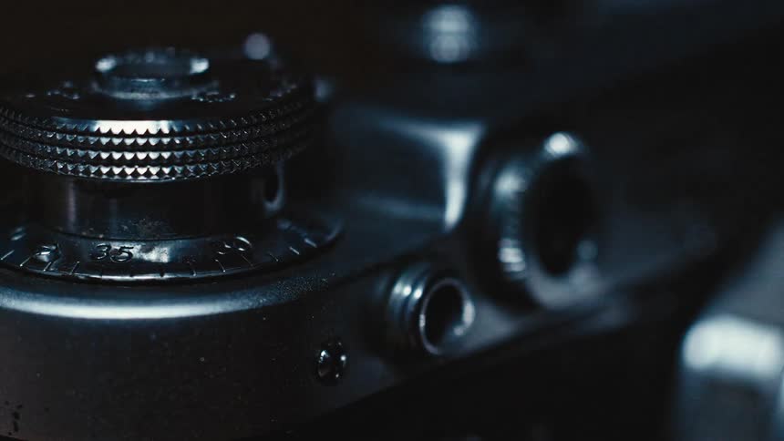 Close up of a black camera adjustment know with light and dark alternating