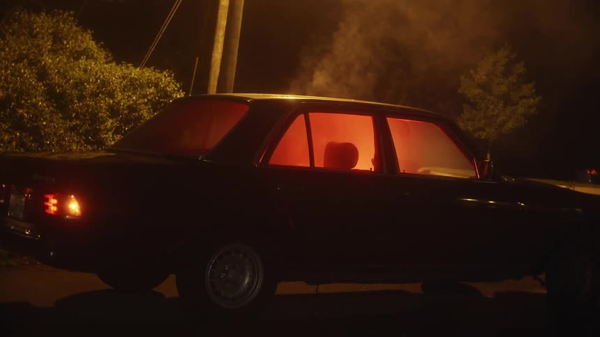 A car is parked outdoors at night