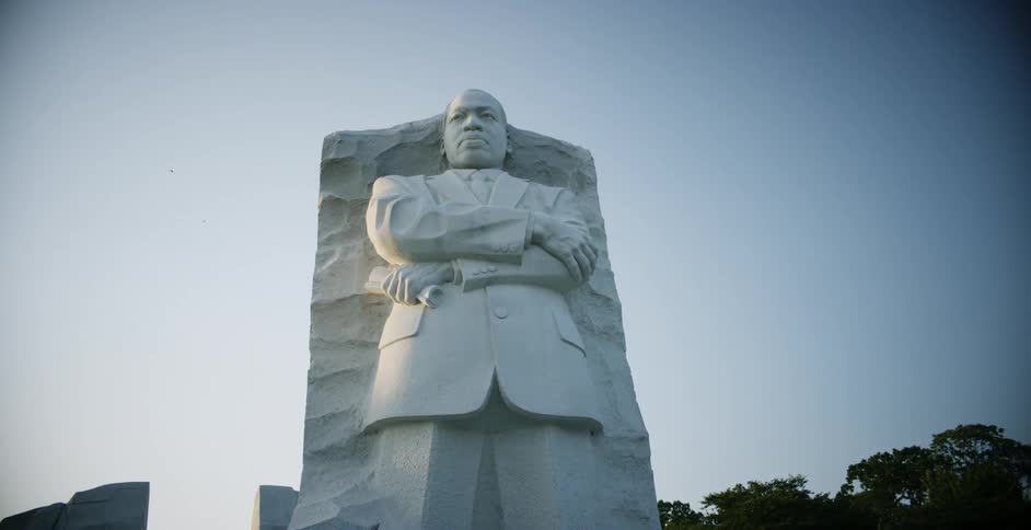 A large stone statue of a man is outside