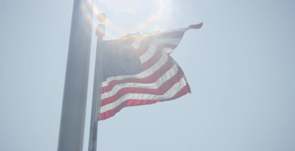 Wind blowing through an american flag on a sunny day