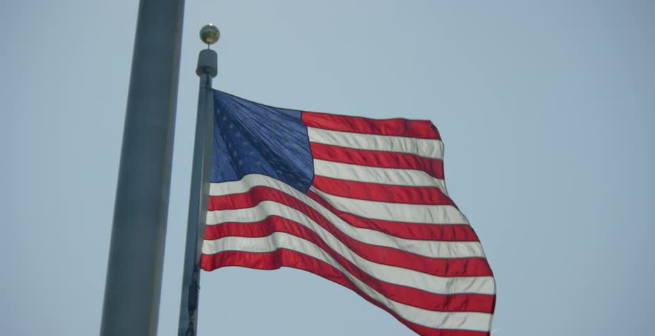An american flag blowing in the wind
