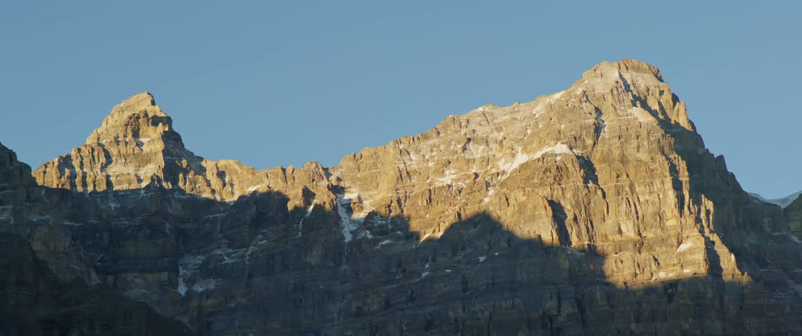 The sun is shining above the rock formation