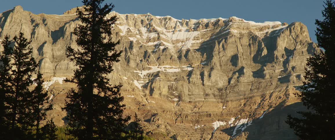 A mountain range against the bright blue sky