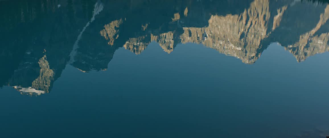 A cliff is reflected in the water