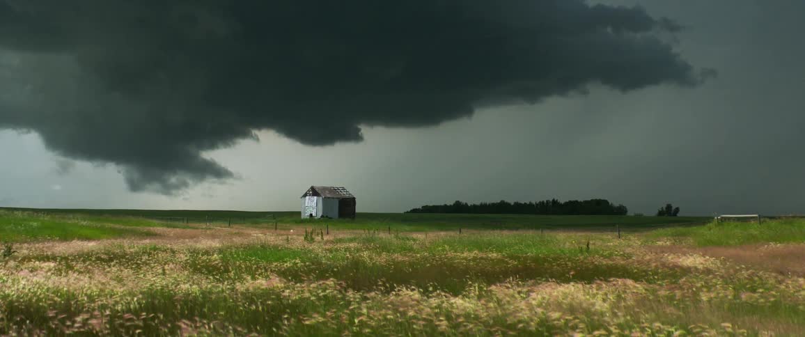Dark storm clouds over a farm field