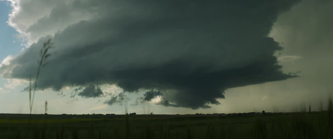 Storm clouds floating over rural fields in the daytime