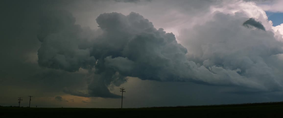 A tornado is forming outdoors at dusk
