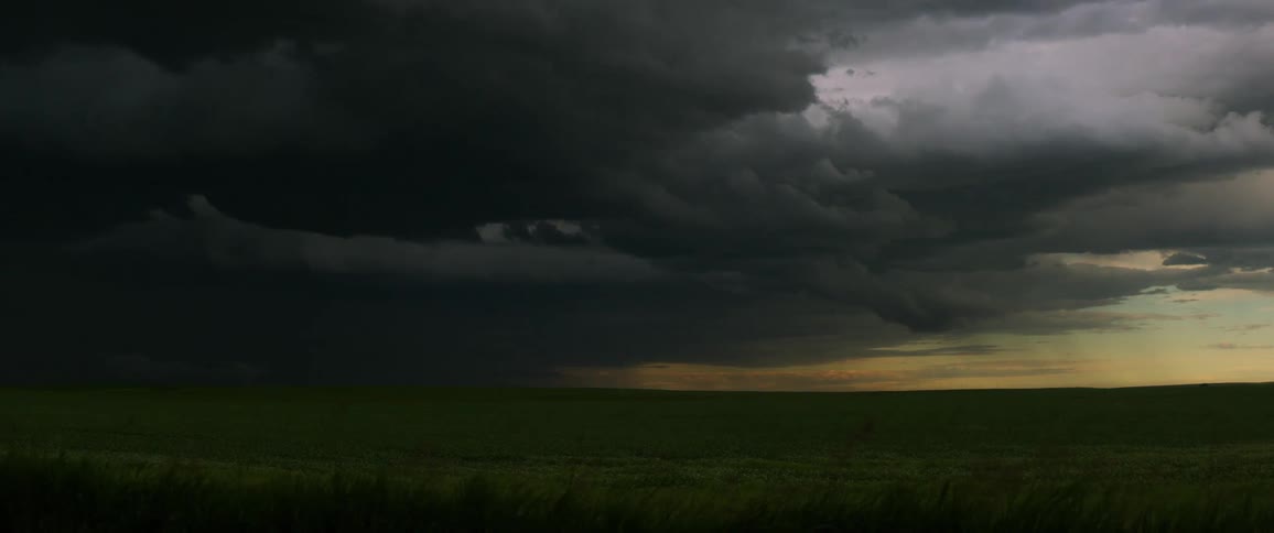Sun fading out as dark storm clouds roll in