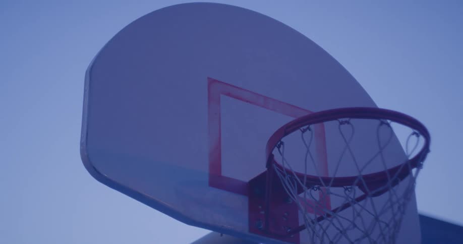 A shot of a basketball rack outdoors at dusk in a city