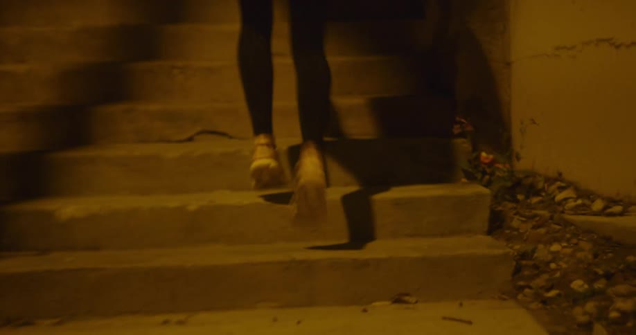 A person is running up a flight of stairs at night