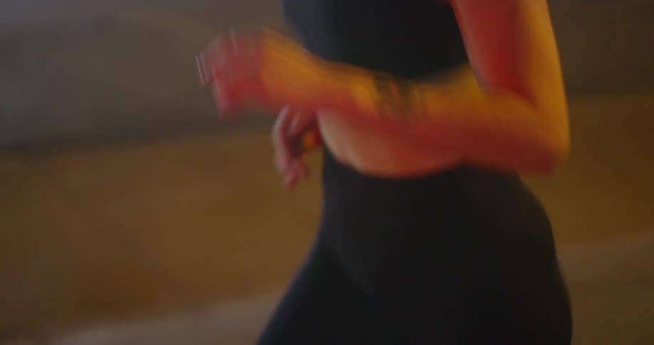 Woman with black sports bra and black leggings running
