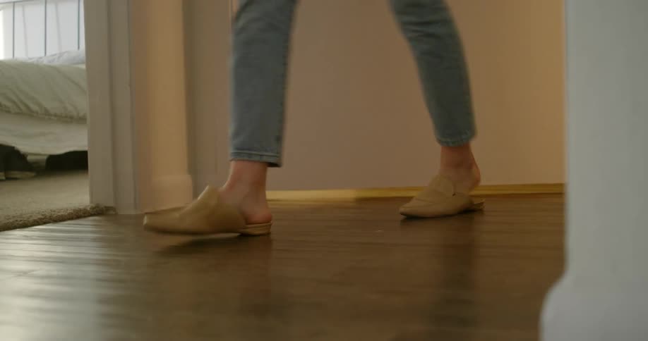 A woman walks out of a room in a home