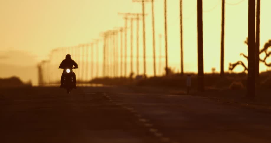 A person driving a motorcycle down a street