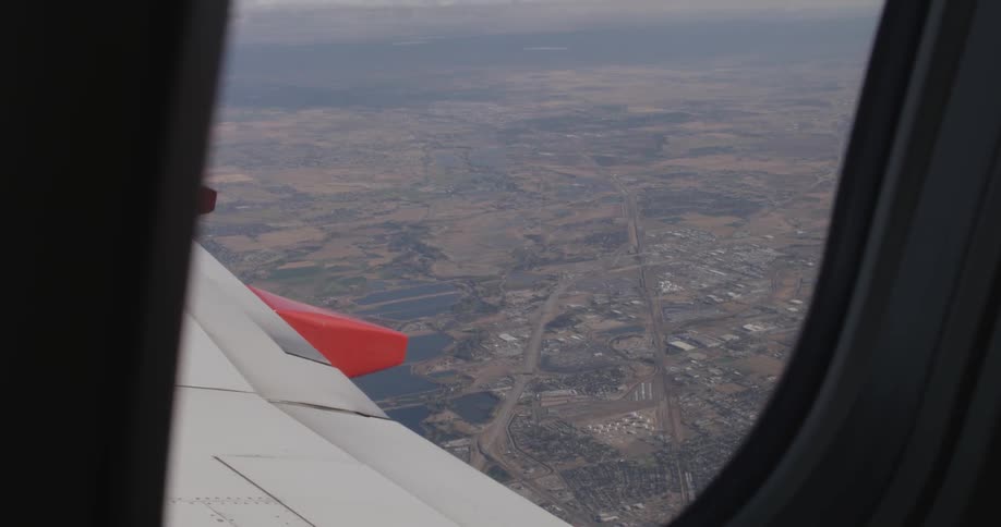 View of a town below from a plane window