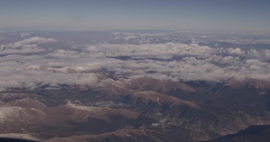 Aerial view of clouds floating over mountains