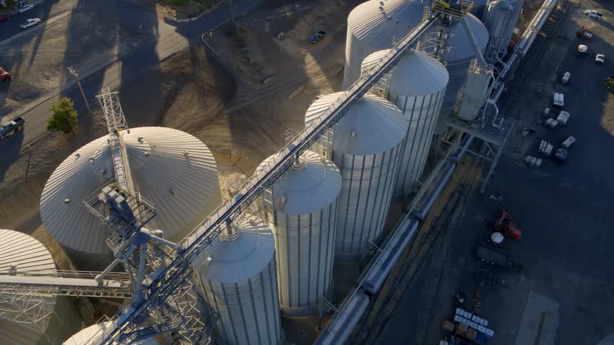 Birds eye view of a grain storage facility in the heart of a small town