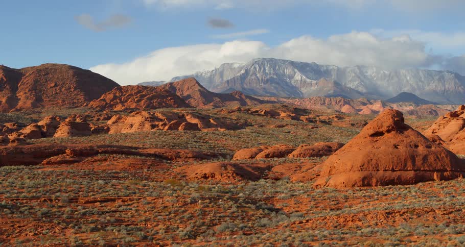 Rock formations in front of mountains covered with clouds