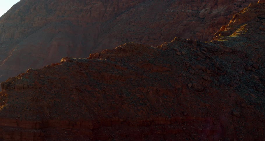 An aerial view of a rocky mountain range in nature on a sunny day