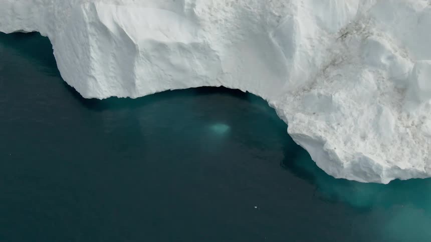 Ocean water in blue green against a stark white glacier