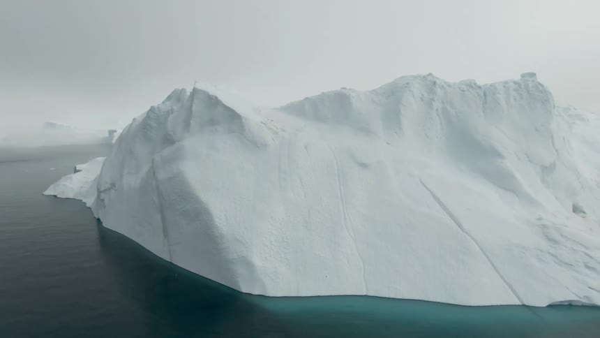 Water flowing around a glacier on a misty day
