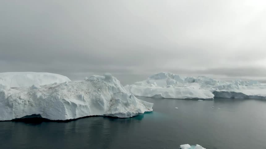 An aerial view of a snowy and icy landscape in nature