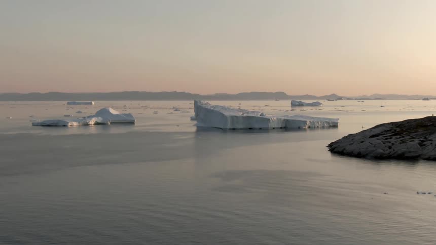 Ocean with ice flows and land in the background