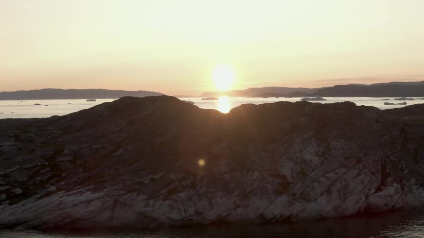 The sun shining over the horizon in the arctic