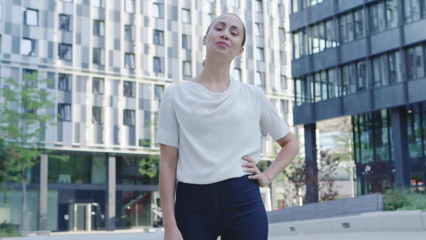 A woman standing outside an office building