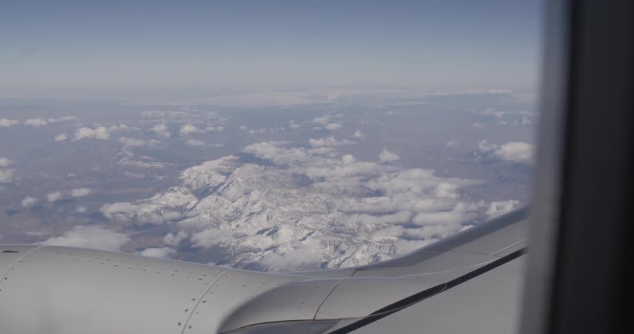 View of snow-capped mountains from an airplane window