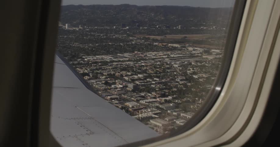 View of a town below from a airplane window