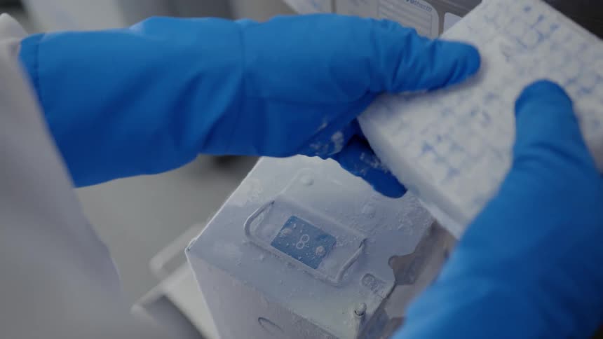 Someone placing a chemical into a batch and then placing the batch in a freezer