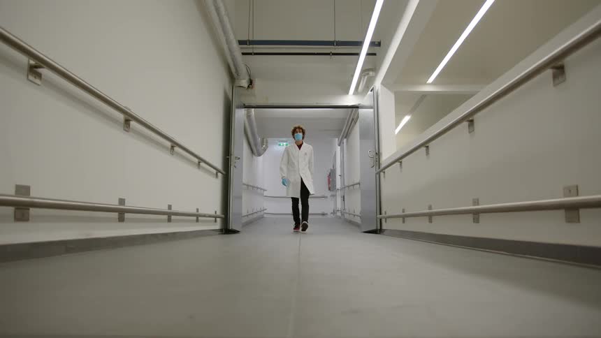 Medical worker walking down an empty corridor
