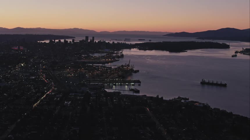 Aerial view of Vancouver City skyline and port at dusk