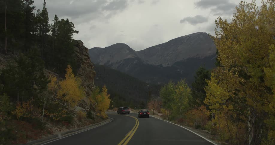 Traveling down a highway surrounded by trees and mountains