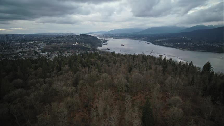 Forest covered hills and a broad inlet on the outskirts of Vancouver city