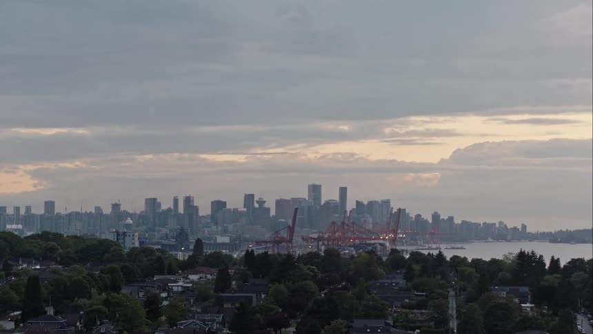 Aerial rises to reveal downtown Vancouver at dusk