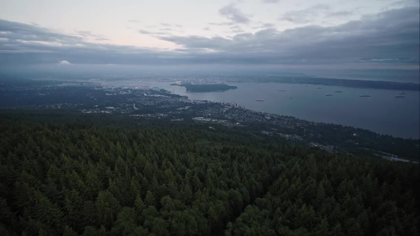Aerial view of downtown Vancouver in distance from North Shore Mountains
